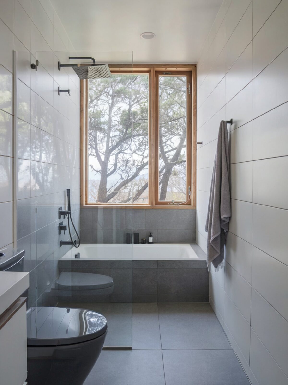 Grey and white bathroom coastal design ideas with floor covered in large gray tiles, and the walls are adorned with white tiles