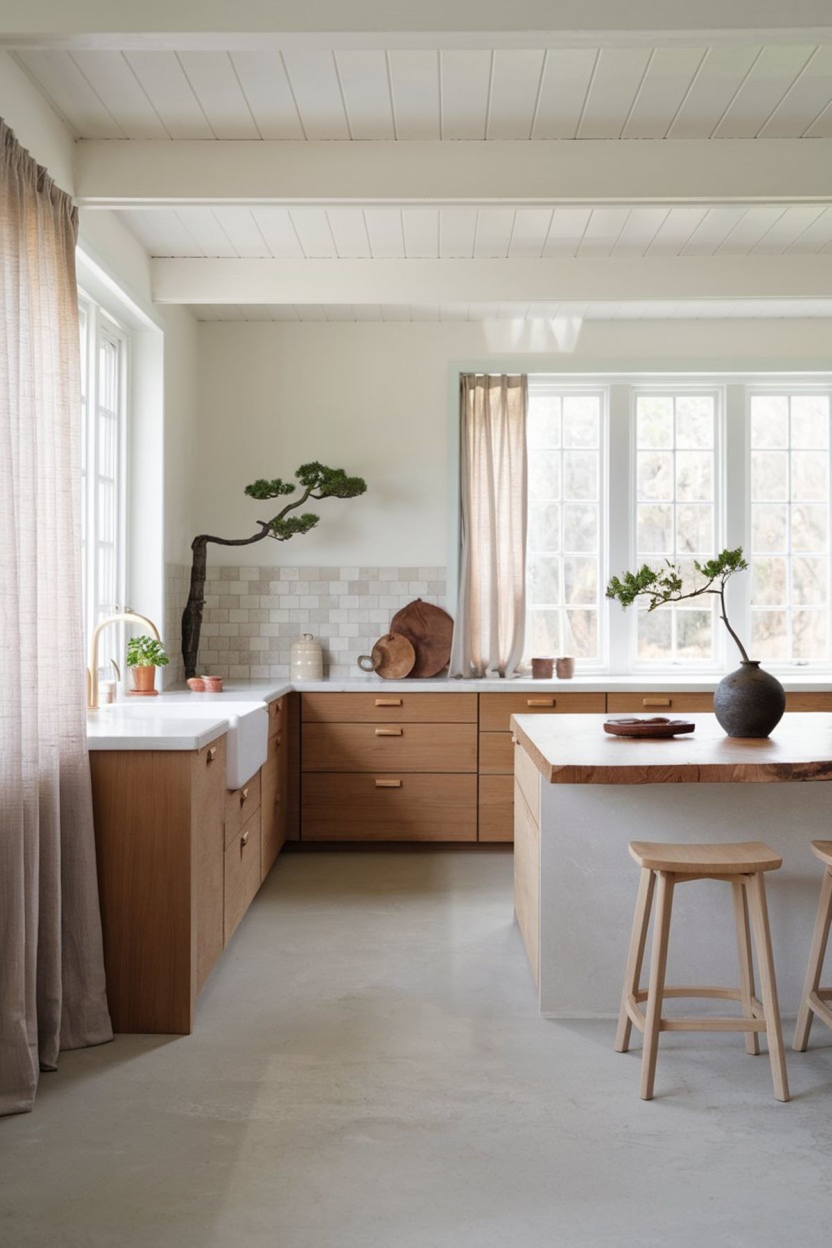 a serene Japandi farmhouse kitchen that beautifully blends Japanese minimalism with rustic farmhouse charm