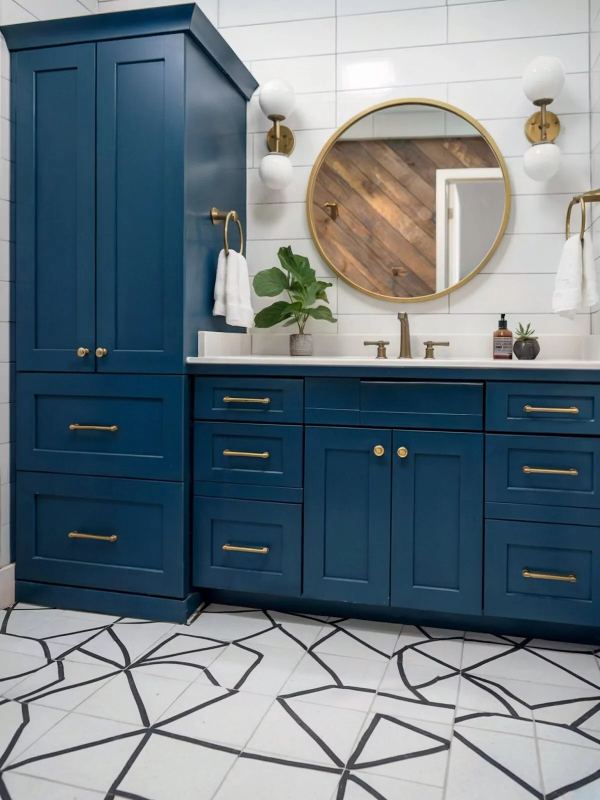 dark blue vanity bathroom ideas farmhouse with a white countertop and a round mirror framed ingold
