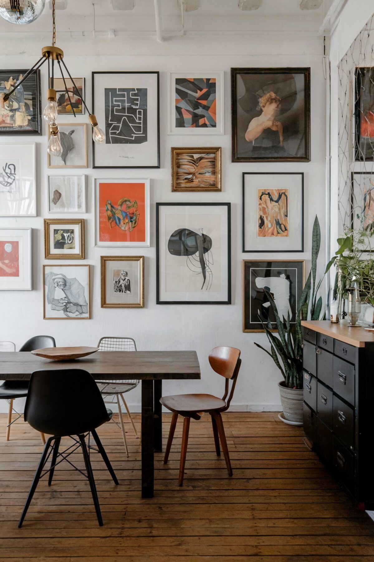eclectic dining room gallery wall brown table white wall
