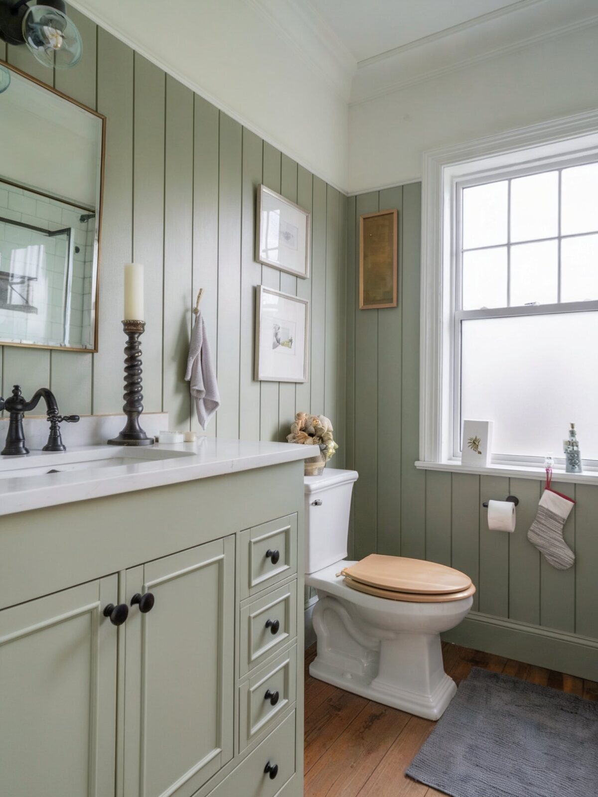 farmhouse bathroom vanity green with a black faucet and a decorative candlestick