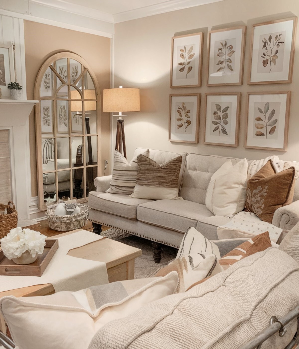 french country living room wall decor ideas above couch walls painted in soft beige featuring framed botanical illustrations above couch