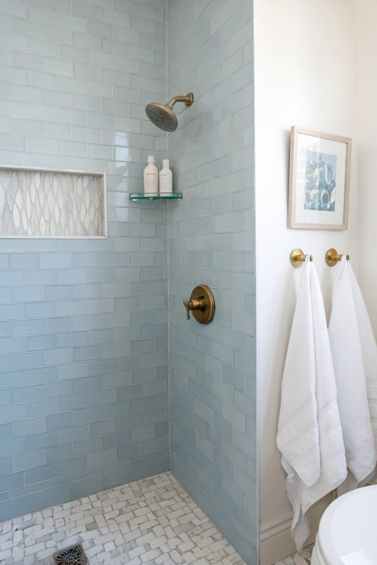 guest bathroom coastal tile a bathroom with a dominant blue tiled wall, leading to a shower area